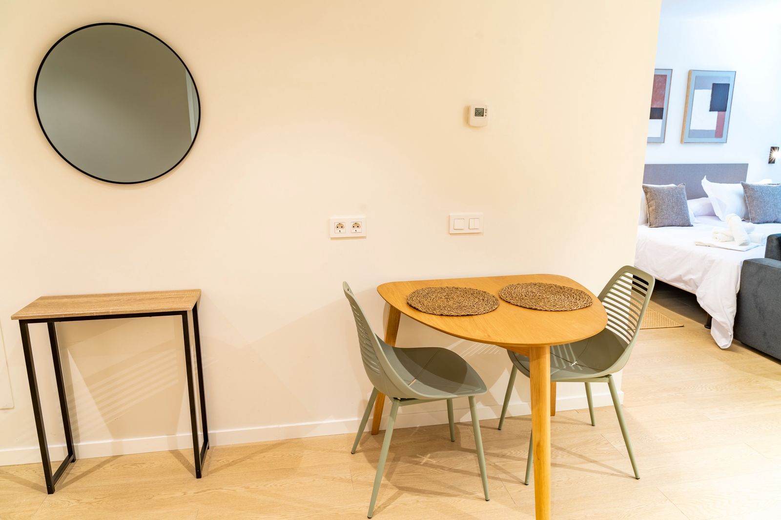 Nook with round mirror, wood console table next to the bedroom